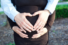 heart hands on pregnant belly